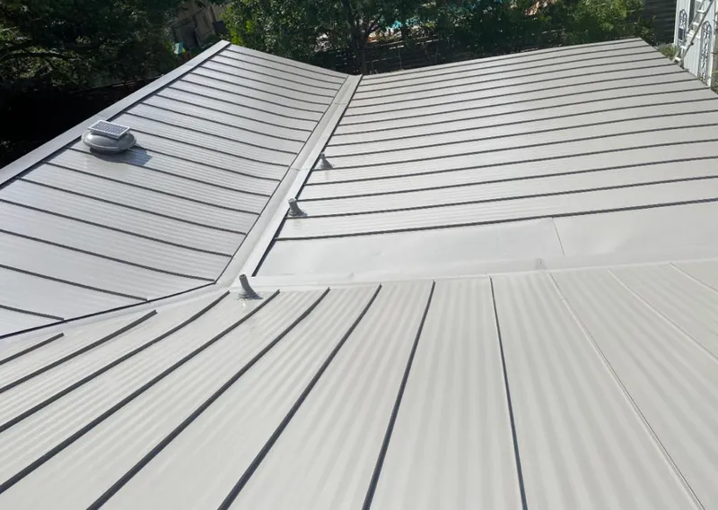 Solar attic fan installed on a metal roof for Roof Ventilation in Tukwila